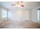 Large carpeted bedroom featuring neutral walls and trim, and natural lighting at 1838 Nicole Ln, Lithonia, GA 30058