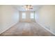 Large, carpeted bedroom featuring neutral walls and trim, and natural lighting from two windows at 1838 Nicole Ln, Lithonia, GA 30058