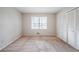 Bedroom with window view and closet with louvered doors at 1838 Nicole Ln, Lithonia, GA 30058