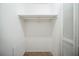 White, shelved closet features a built-in clothing rack and blank space for storage at 1838 Nicole Ln, Lithonia, GA 30058