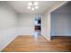 Dining area features hardwood floors, modern lighting, and white wainscoting at 1838 Nicole Ln, Lithonia, GA 30058