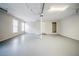 Large garage with two windows, a central support beam, and a utility door at 1838 Nicole Ln, Lithonia, GA 30058