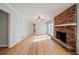Cozy living room with brick fireplace and hardwood floors, perfect for relaxing or entertaining at 1838 Nicole Ln, Lithonia, GA 30058