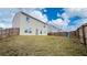 Large, grassy backyard featuring a privacy fence, perfect for outdoor living at 720 Dove Tree Ln, Social Circle, GA 30025