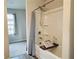 Bright bathroom featuring shower-tub combination with white tile surround at 720 Dove Tree Ln, Social Circle, GA 30025