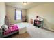 Cozy bedroom with a bed, study desk and carpet floor at 720 Dove Tree Ln, Social Circle, GA 30025