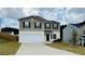 Two story home featuring a two car garage and neutral exterior paint at 720 Dove Tree Ln, Social Circle, GA 30025