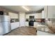 Modern kitchen featuring stainless steel appliances, granite countertops and white cabinets at 720 Dove Tree Ln, Social Circle, GA 30025