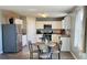 Bright eat-in kitchen featuring stainless steel appliances, white cabinetry and wood-look floors at 720 Dove Tree Ln, Social Circle, GA 30025