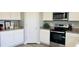 Bright kitchen with stainless steel appliances, granite countertops, and white cabinets at 720 Dove Tree Ln, Social Circle, GA 30025
