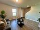 Living room with wood floors, neutral paint and a large window at 720 Dove Tree Ln, Social Circle, GA 30025