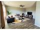 Spacious living room with stylish furnishings, a ceiling fan, and wood-look flooring at 720 Dove Tree Ln, Social Circle, GA 30025