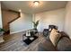 Living room features neutral paint, wood floors, and a staircase at 720 Dove Tree Ln, Social Circle, GA 30025