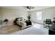 Spacious main bedroom featuring a ceiling fan, a large window, and a dedicated work space at 720 Dove Tree Ln, Social Circle, GA 30025