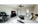 Cozy main bedroom featuring a ceiling fan, a workspace and access to the ensuite bath at 720 Dove Tree Ln, Social Circle, GA 30025