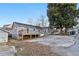 Grey house exterior featuring a wooden deck, an adjacent shed, a dry lawn, and cracked concrete at 1268 Wylie Se St, Atlanta, GA 30317