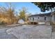 Exterior of a grey house and an adjacent shed, surrounded by patchy grass, dry leaves, and cracked concrete at 1268 Wylie Se St, Atlanta, GA 30317