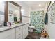 Bathroom features a granite countertop, patterned shower curtain, and tile floor and walls at 1268 Wylie Se St, Atlanta, GA 30317