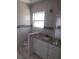 Bathroom featuring a granite countertop vanity and tiled walls at 1268 Wylie Se St, Atlanta, GA 30317