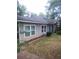 Side view of the home, showcasing the gray siding, double-pane windows, and well-manicured lawn at 1268 Wylie Se St, Atlanta, GA 30317