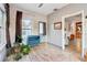 Bright living room features wood-look tile floors, brick accent wall, and a blue cabinet at 1268 Wylie Se St, Atlanta, GA 30317