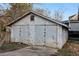 Exterior front view of a shed with damaged metal siding and an adjacent concrete pad at 1268 Wylie Se St, Atlanta, GA 30317