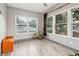 Sun Room featuring light gray walls, wood floors, and three large windows at 1268 Wylie Se St, Atlanta, GA 30317