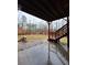 Backyard view with wooden staircase, lawn and wooded background at 1831 Nours Landing Way, Duluth, GA 30097