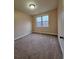 Cozy carpeted bedroom with a large window bringing in plenty of natural light at 1831 Nours Landing Way, Duluth, GA 30097