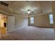 Spacious bedroom with plush carpet, large windows, and tray ceiling with ceiling fan at 1831 Nours Landing Way, Duluth, GA 30097