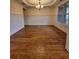 Bright dining area with wainscoting, a tray ceiling, and hardwood flooring at 1831 Nours Landing Way, Duluth, GA 30097