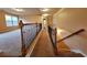 Hallway showing wood and iron railings, plush carpet and access to additional rooms at 1831 Nours Landing Way, Duluth, GA 30097