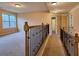 Carpeted second-floor hallway featuring wood and iron railing and natural lighting at 1831 Nours Landing Way, Duluth, GA 30097