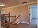 Upstairs hallway boasts plush carpet, wood and iron railing, and neutral walls at 1831 Nours Landing Way, Duluth, GA 30097