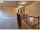 Upstairs hallway with plush carpet, railing, and neutral color palette at 1831 Nours Landing Way, Duluth, GA 30097