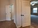 Hallway with tan tile flooring leading to bedroom with ceiling fan and recessed lighting at 1831 Nours Landing Way, Duluth, GA 30097