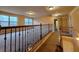 Second-floor hallway with plush carpet, railing and natural light at 1831 Nours Landing Way, Duluth, GA 30097