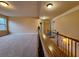 Upstairs landing featuring neutral paint, plush carpeting and wood and iron railings at 1831 Nours Landing Way, Duluth, GA 30097