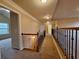 Bright upstairs hallway with wood and iron railing and neutral walls at 1831 Nours Landing Way, Duluth, GA 30097