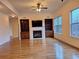 Bright living room with hardwood floors, fireplace, and custom built-in shelves at 1831 Nours Landing Way, Duluth, GA 30097