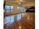 Spacious living room with fireplace, hardwood floors, and view into the kitchen at 1831 Nours Landing Way, Duluth, GA 30097