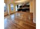 Open-concept living room flows into a kitchen with dark cabinets and hardwood floors at 1831 Nours Landing Way, Duluth, GA 30097