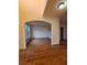 Open living room with hardwood floors and a arched entryway at 1831 Nours Landing Way, Duluth, GA 30097