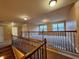 Upper level loft area with hardwood floors, neutral walls, and plenty of natural light at 1831 Nours Landing Way, Duluth, GA 30097