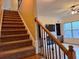 Carpeted staircase with decorative railing leading to an open living area at 1831 Nours Landing Way, Duluth, GA 30097