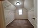 Walk-in closet with wire shelving, carpeted flooring, and a window for natural light at 1831 Nours Landing Way, Duluth, GA 30097