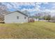 Well-manicured lawn and backyard, featuring a charming wooden deck, set under a blue sky at 6297 Temple St, Lithia Springs, GA 30122