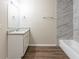 Modern bathroom featuring wood-look floors, granite countertop, and a tiled shower at 6297 Temple St, Lithia Springs, GA 30122