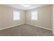 Comfortable bedroom with plush carpet and natural light from two windows at 6297 Temple St, Lithia Springs, GA 30122