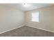 Cozy bedroom with neutral walls, plush carpet, and natural light at 6297 Temple St, Lithia Springs, GA 30122